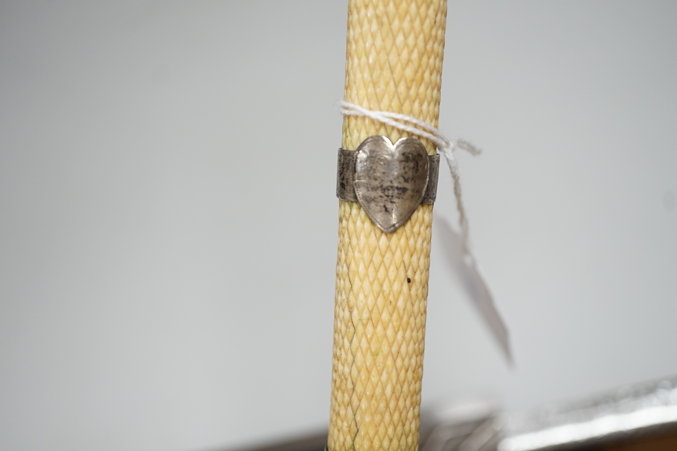 A 19th century scrimshaw whalebone walking cane with white metal mounts, length 69cm
